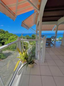 a porch of a house with a view of the ocean at Villa Sunrise in Deshaies