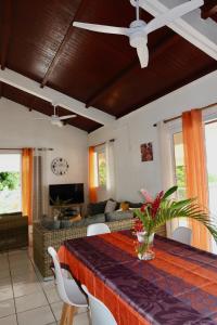 a living room with a table and a couch at Villa Sunrise in Deshaies