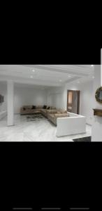 1 dormitorio con 1 cama grande y pared blanca en Sweet home three bedroom house en Sousse