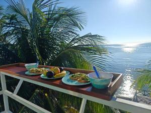 a table with two plates of food on it with the water at Villa on The Beach Seaside Sunrise Haven 7 bedroom in Cancún