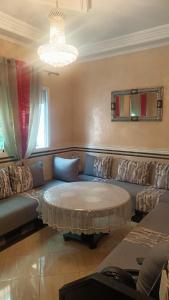 a living room with a couch and a coffee table at Chez hafid in Fez