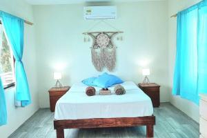 a bedroom with a bed with blue walls and blue curtains at Villa on The Beach Seaside Sunrise Haven 7 bedroom in Cancún