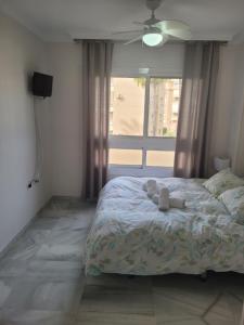 a bedroom with a bed with two towels on it at CasaBel - Playa in Torrox Costa