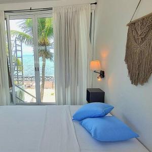 a bedroom with a bed with a view of the ocean at Villa on The Beach Seaside Sunrise Haven 7 bedroom in Cancún