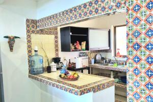a kitchen with a bowl of fruit on a counter at Villa on The Beach Seaside Sunrise Haven 7 bedroom in Cancún