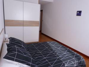 a bedroom with a bed and a glass wall at Eguzkilore - Apartamento luminoso y soleado in Elizondo
