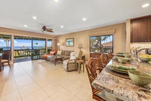 a kitchen and living room with a view of the ocean at Kaanapali Plantation 53 in Lahaina