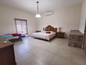 A bed or beds in a room at Hidden Hacienda with private pool