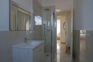 a white bathroom with a sink and a shower at L’Archè Comfort&Relax – Old Style House in Milan