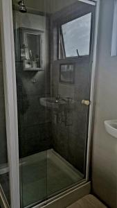 a glass shower in a bathroom with a sink at Angel 8 AirBnB Apartment 1 in Robertson