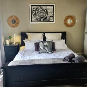 a bed with white sheets and pillows in a bedroom at Angel 8 AirBnB Apartment 1 in Robertson