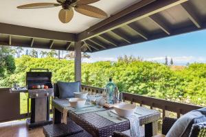 a patio with a table and chairs and a ceiling fan at Kaanapali Plantation 58 in Lahaina