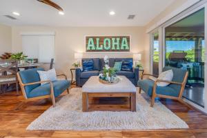 a living room with two blue chairs and a table at Kaanapali Plantation 58 in Lahaina
