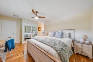 a bedroom with a bed and a desk and a ceiling fan at Kaanapali Plantation 58 in Lahaina