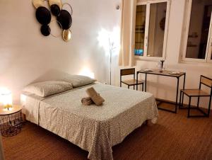 a bedroom with a bed with a teddy bear on it at Studio Cosy(5mn Paris)Metro/RER in Alfortville