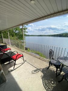 a screened in porch with a view of a lake at L'Oasis in Ascot Corner