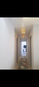 an empty hallway with a chandelier in a room at شقه للايجار المفروش في مدينتي Ad3. 01099725816 in Madinaty