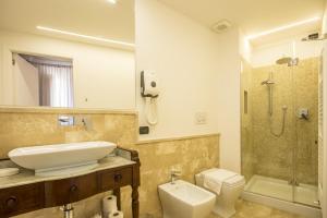 a bathroom with a sink and a toilet and a shower at A Palazzo Busdraghi Residenza D'Epoca in Lucca +53 photos
