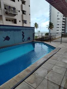 a swimming pool in front of a building at BOA VIAGEM FLATS APTO 201 in Recife
