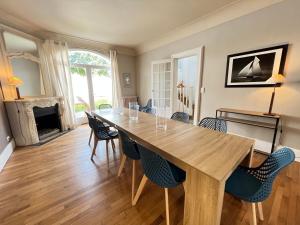 a dining room with a wooden table and chairs at La Villa Maignan - Centre ville - Jardin - 15p in Le Mans
