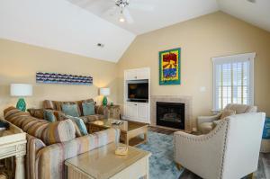 a living room with a couch and a fireplace at 1606 - Shades of Sand in Corolla