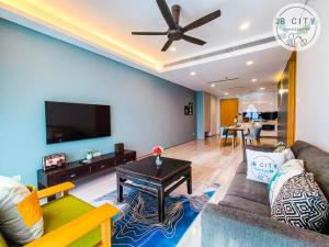 a living room with a couch and a table at Pine Tree HardRock Suites by JBcity Home in Kampong Baharu