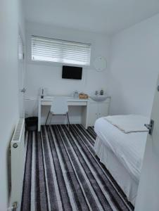TV a/nebo společenská místnost v ubytování Aaran Central Guesthouse