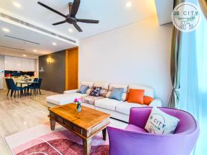 a living room with a couch and a table at Pine Tree HardRock Suites by JBcity Home in Kampong Baharu