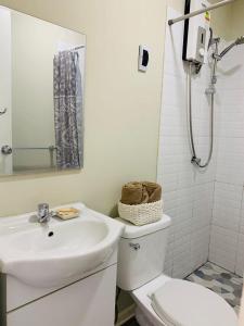 a white bathroom with a sink and a toilet at Miski House 2 in Urbanizacion Buenos Aires