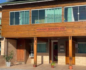 a wooden building with the words morocco designer at Moradas Desterro, próximo ao aeroporto 03 in Florianópolis