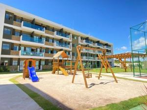 a playground in front of a apartment building at Mana Beach Experience in Ipojuca