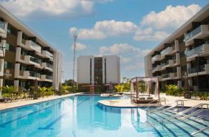 a large swimming pool in front of two buildings at Mana Beach Experience in Ipojuca