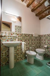 a bathroom with a sink and a toilet at Agriturismo Tenuta Castel Venezze in San Martino di Venezze
