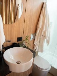 a bathroom with a sink and a toilet and a mirror at Valle Fiori in Balsa Nova +50 photos
