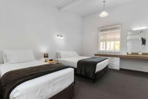 Postel nebo postele na pokoji v ubytování Econo Lodge East Adelaide + 28 fotografií