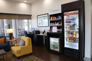 a grocery store with a cash register and a refrigerator at Comfort Suites Clearwater - Dunedin in Clearwater