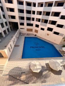 a building with a swimming pool in front of a building at Princess Resort (Rayan) in Hurghada