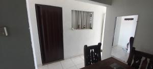 a dining room with a table and a refrigerator at Casa acogedora en girardot in Girardot
