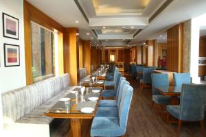 a row of tables and chairs in a restaurant at The Place Gurugram, a member of Radisson Individuals in Gurgaon