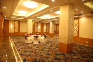 a banquet hall with tables and chairs in a building at The Place Gurugram, a member of Radisson Individuals in Gurgaon