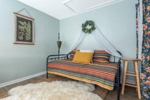 a bedroom with a bed with a canopy at Blue Beach Cottage in Delavan