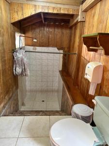 a bathroom with a shower and a toilet at La Casa de Cecilia Mindo in Mindo