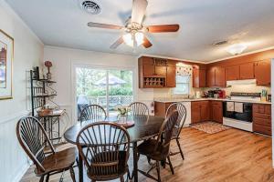 a kitchen with a table with chairs and a ceiling fan at Kelly's Comfortable Quinton Home in Quinton