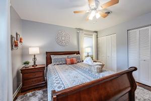 a bedroom with a bed and a ceiling fan at Kelly's Comfortable Quinton Home in Quinton
