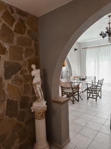 a statue of a man on a column in a room at Theonia Villas in Pefki Rhodes