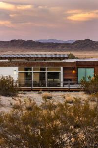 a building in the middle of the desert at Panoramic Heaven - Luxury Designer Property w Spa in Joshua Tree