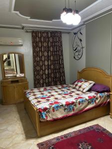 a bedroom with a bed and a mirror at Al Moayad Abbas Al Akkad Hotel in Cairo