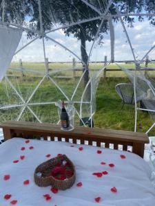 a bed in a tent with red hearts on it at Country Bumpkins Luxury Igloo in Wellingore