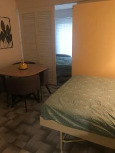 a bedroom with a bed and a table and a lamp at Agde : appartement vue sur le port in Cap d'Agde +7 photos