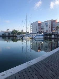 un port de plaisance avec des bateaux dans l'eau et des bâtiments dans l'établissement Agde : appartement vue sur le port, au Cap d'Agde